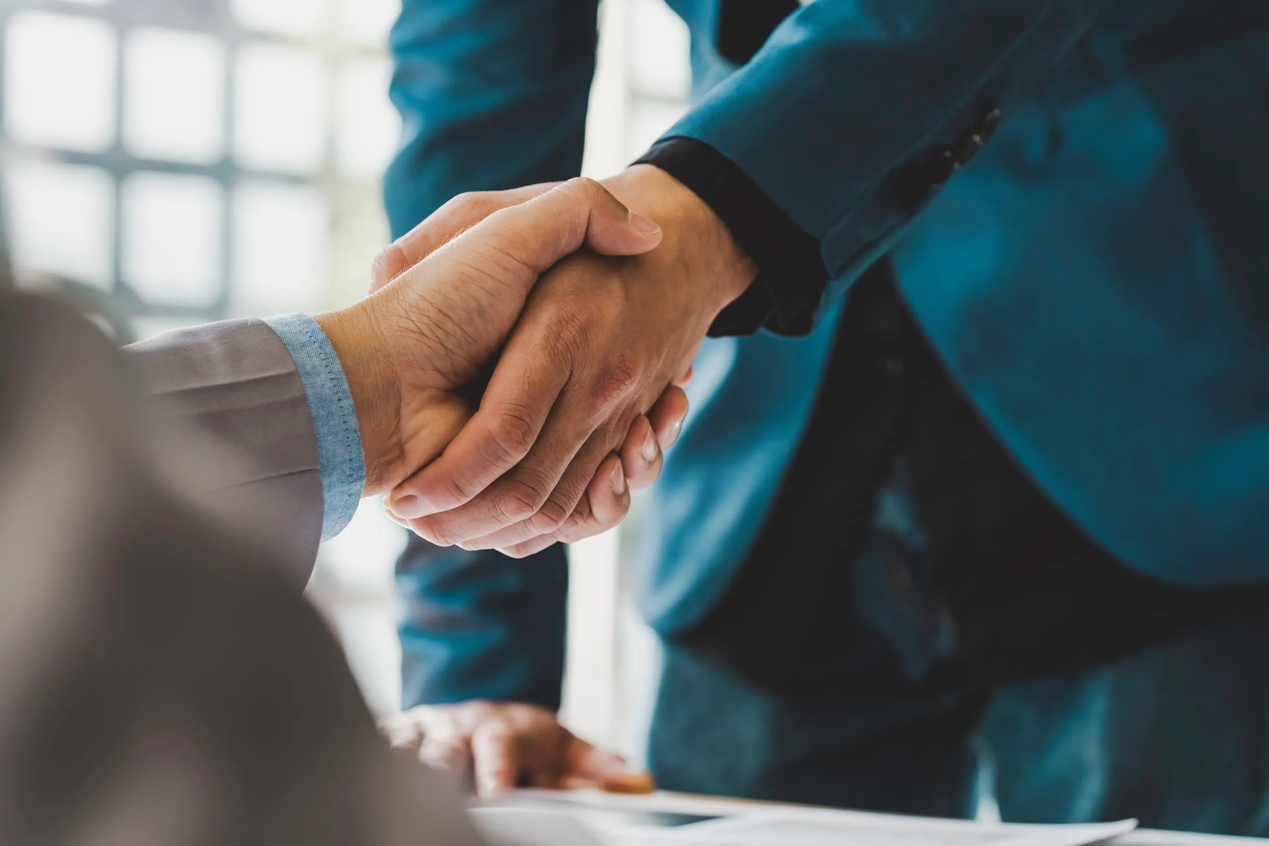 Two people shaking hands after a meeting