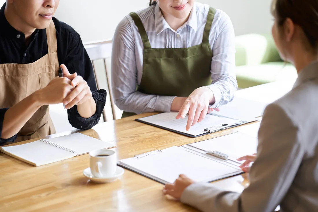 Colleagues reviewing paperwork together at a table