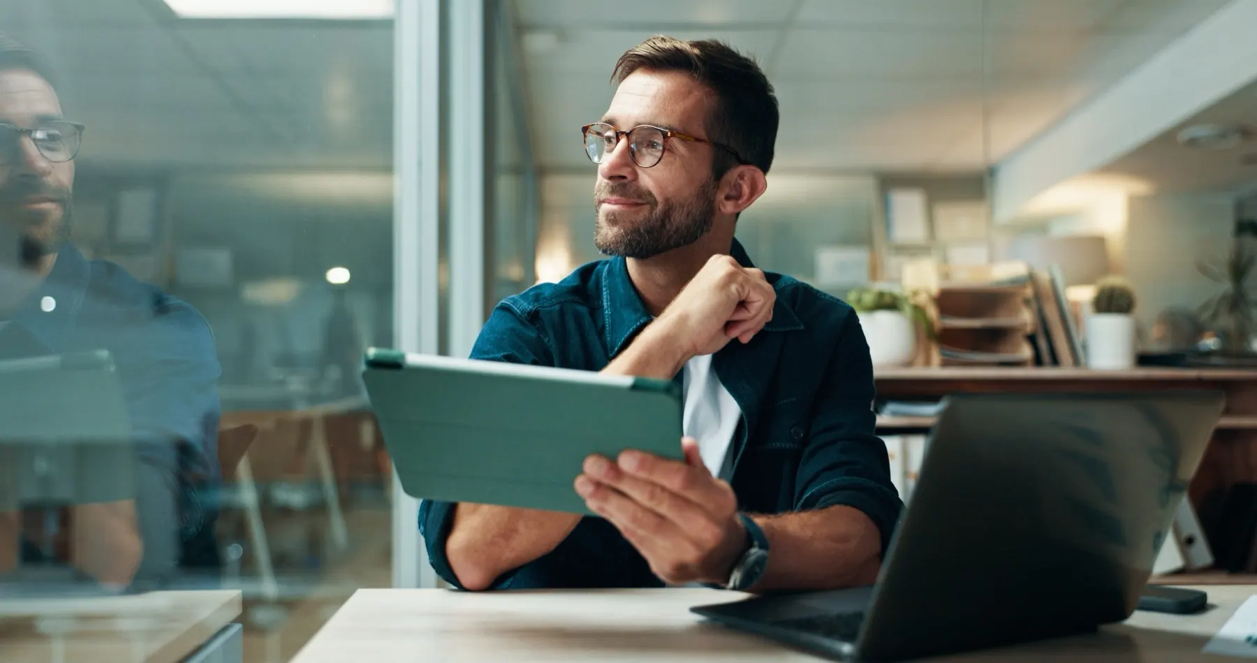 A professional reviewing figures on a tablet